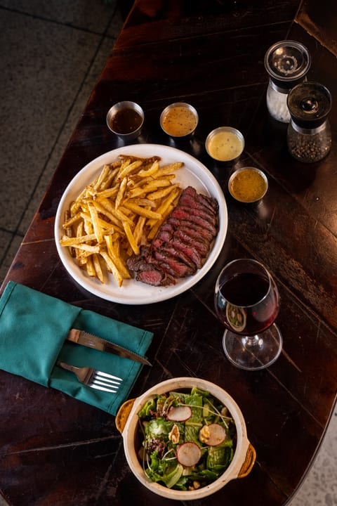 Steak and Fries with sauces and red wine at Le Café des Stagiaires