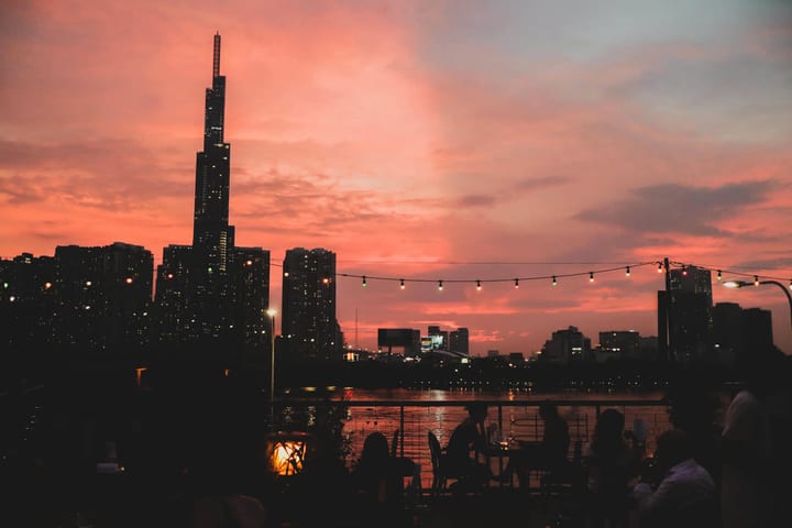 Sunset over the Saigon River and Landmark 81 from Le Café des Stagiaires rooftop