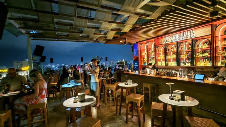 Social Club Rooftop Bar interior with city skyline
