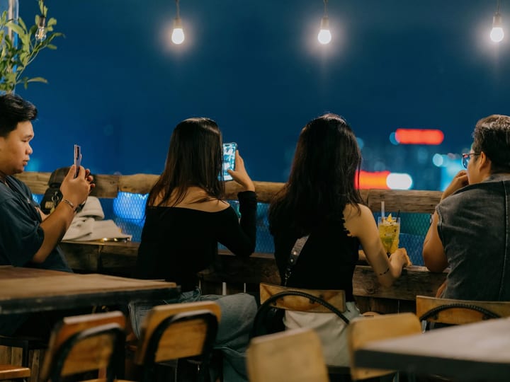 Chenh Venh in Thao Dien with guests facing the night skyline
